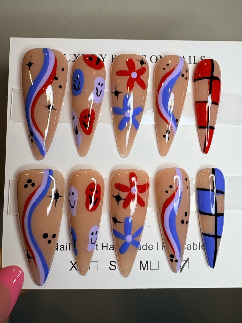 Handpainted Nude Stiletto Press-On Nails with Red & Blue Accents - Picture 2 of 3